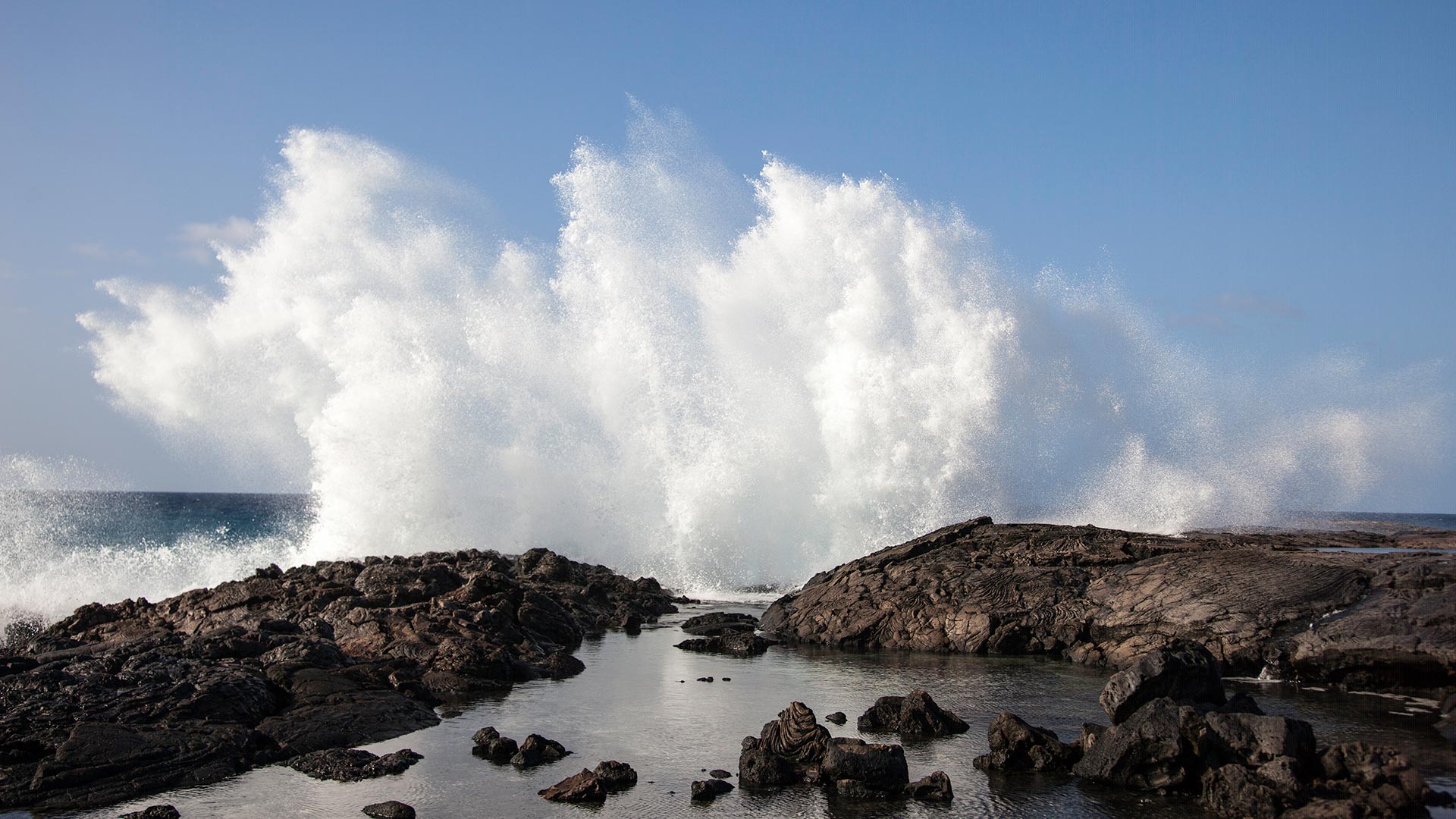 Dramatic geography features lava fields rolling out to the big Pacific