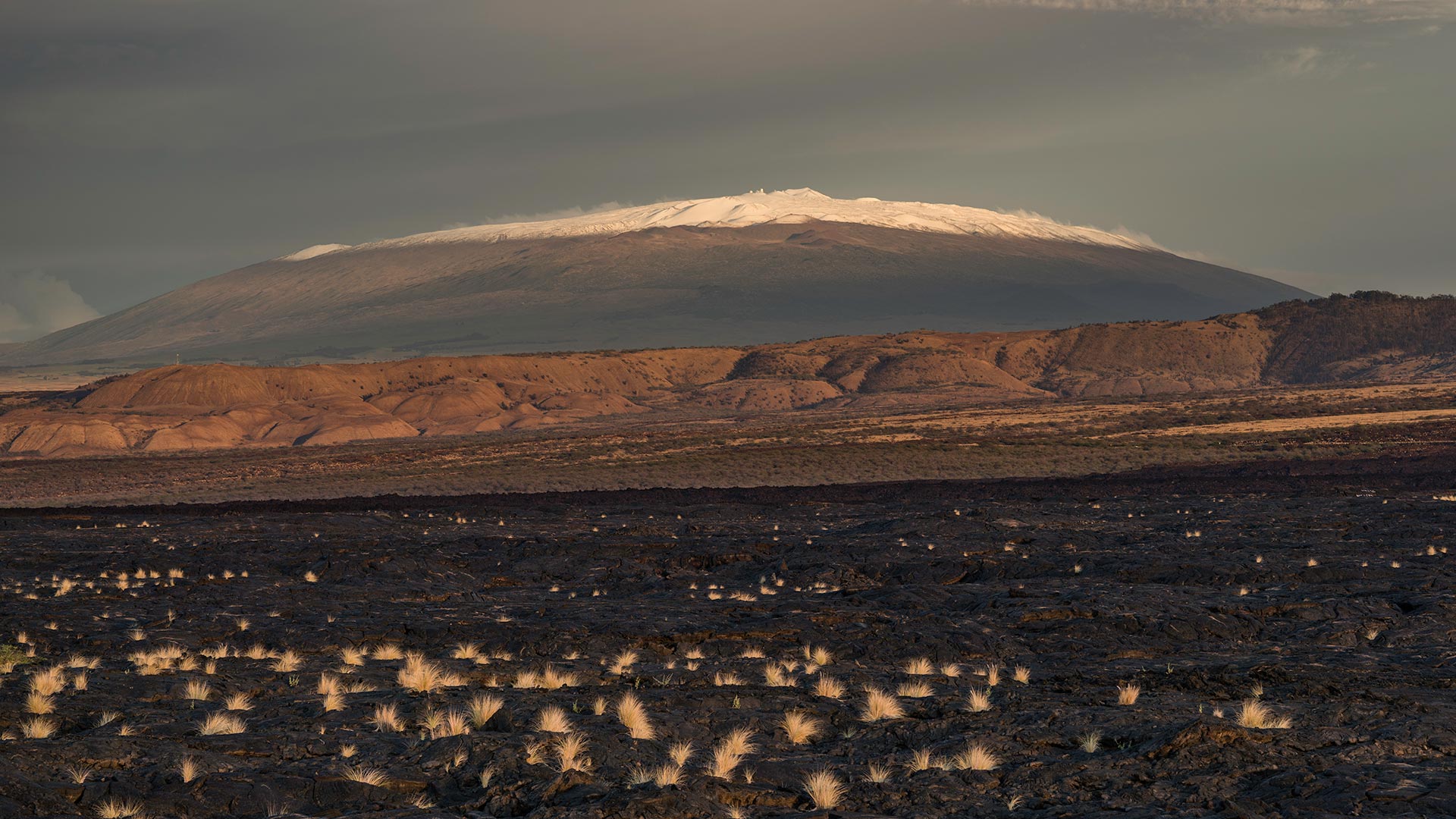 The dormant volcano Mauna Kea towers over the landscape